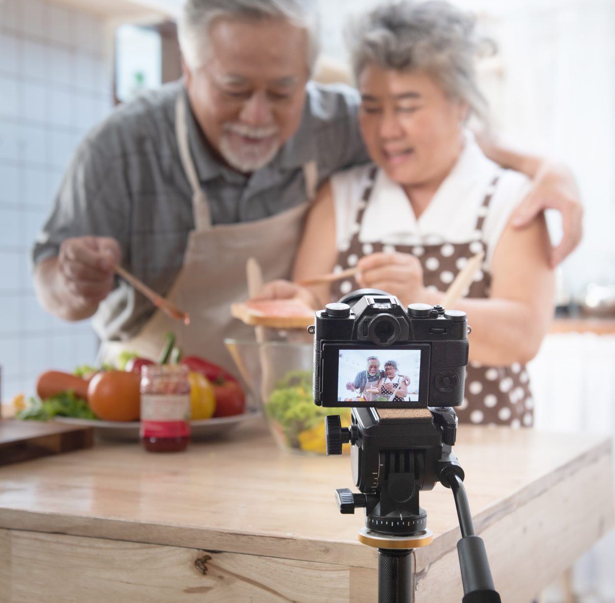 A couple recording video cooking lessons